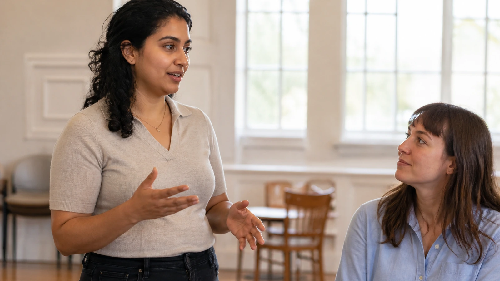 An adult candidate practises a concise answer with a supportive peer